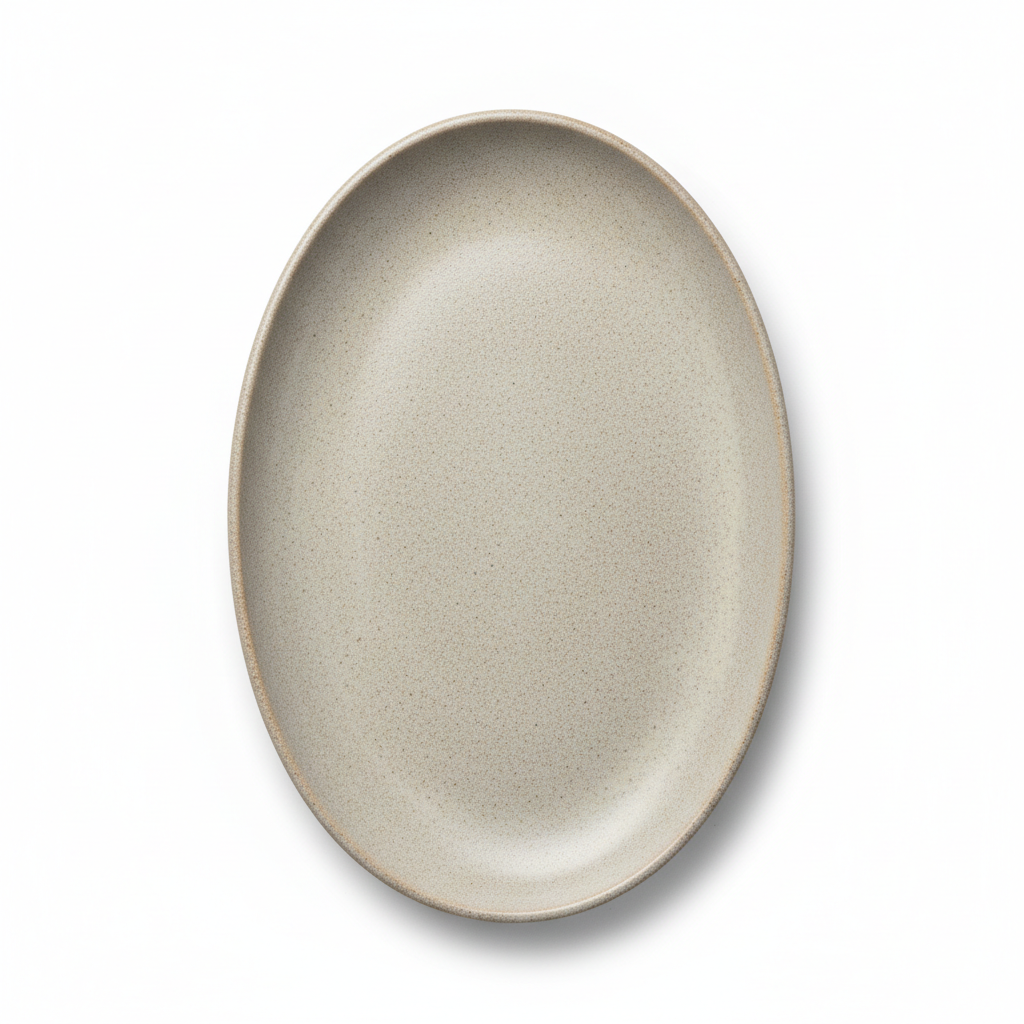 Large oval ceramic serving platter with ivory glaze on a rustic wooden dining table