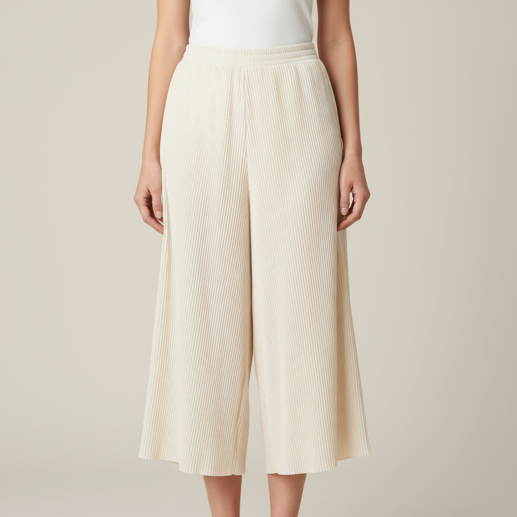 Pleated culottes in cream, model walking in bright open courtyard, natural daylight