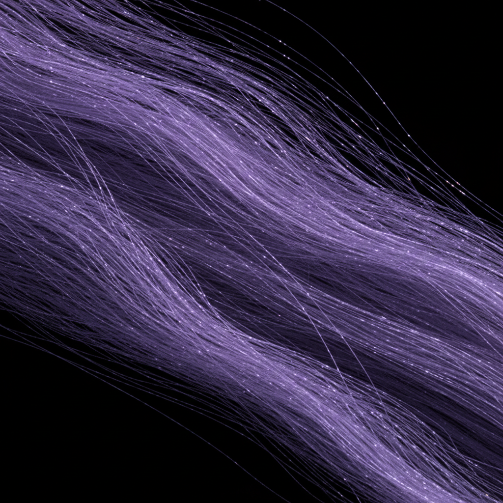 Microscopic view of ultra-fine merino fibers showing uniform diameter against dark background with violet light
