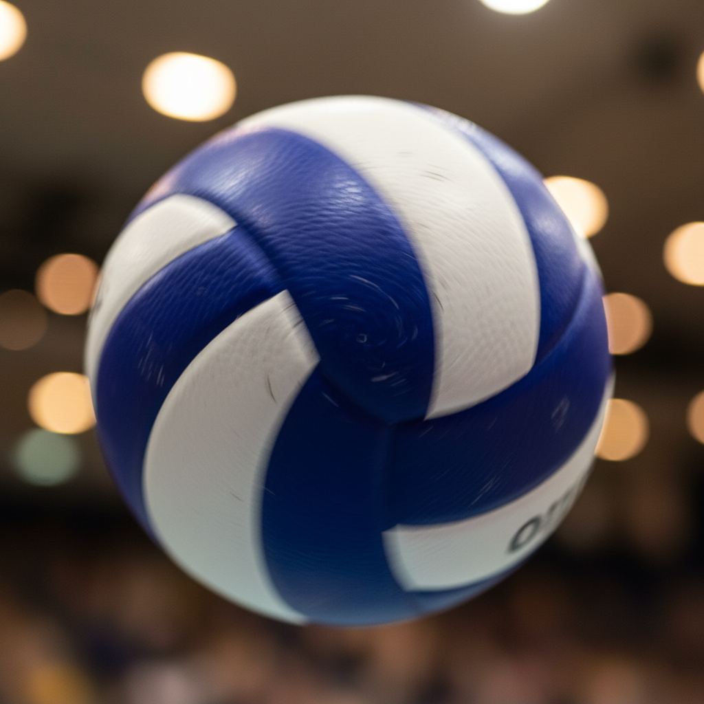 Close-up volleyball frozen mid-spin with gymnasium bokeh lights behind it, sweat visible on player's wrist