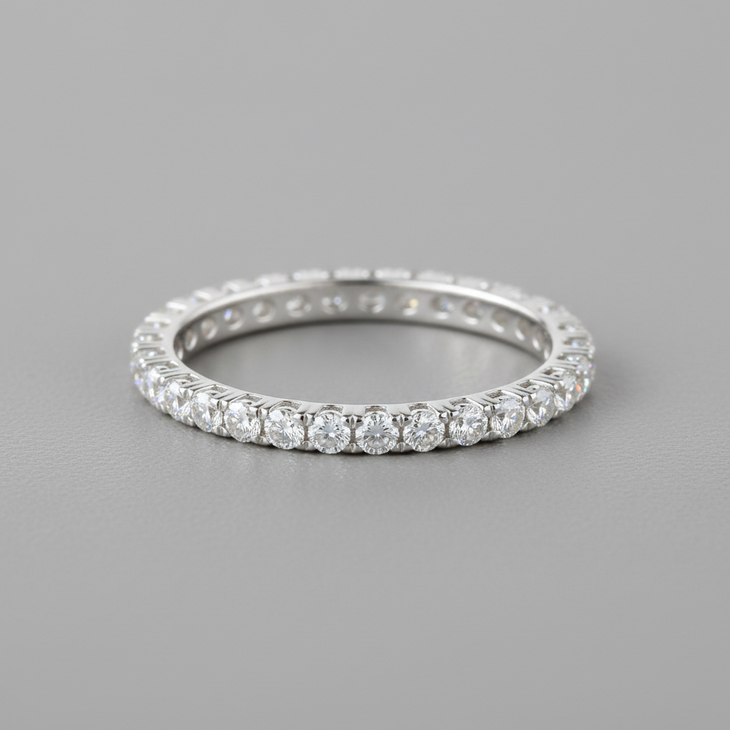 Platinum pavé diamond eternity band ring on dark stone surface with dramatic lighting