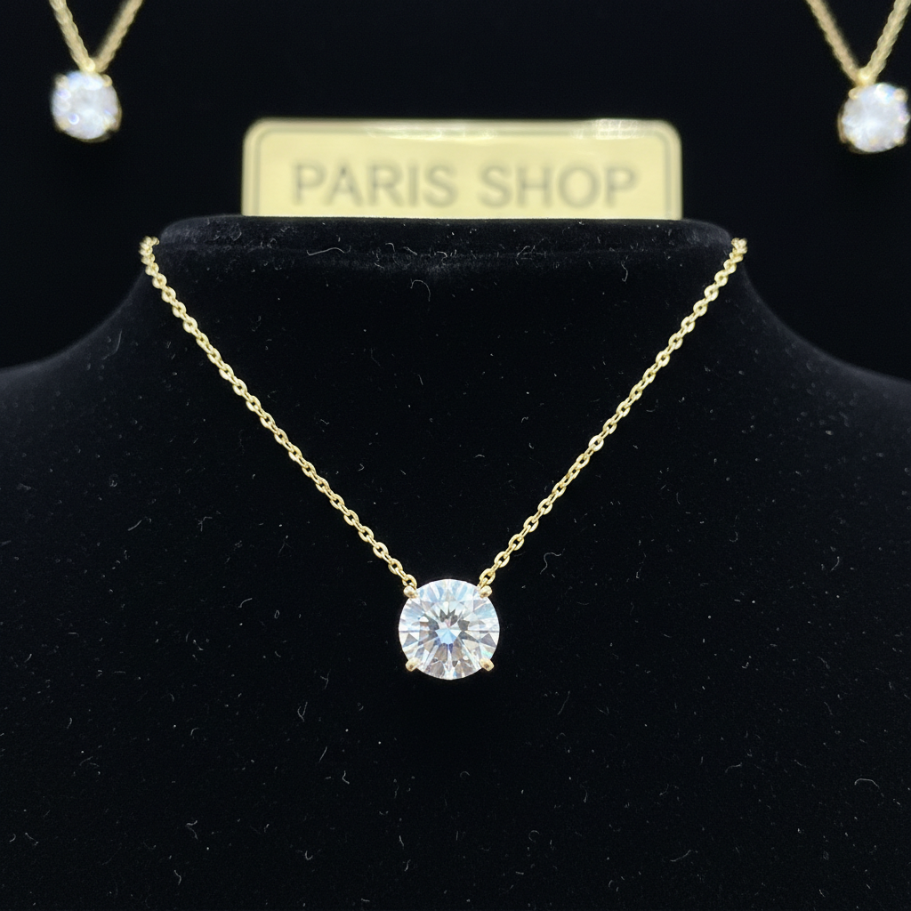 Emerald pendant necklace in gold setting displayed on dark velvet