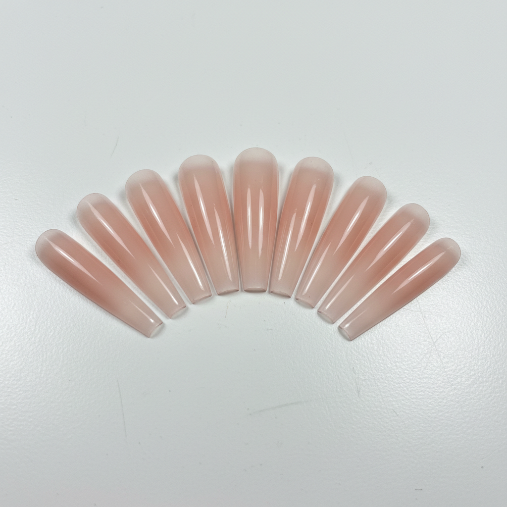 Long coffin nail extensions with crystal ombre gradient and rhinestone accents, bright clean studio backdrop