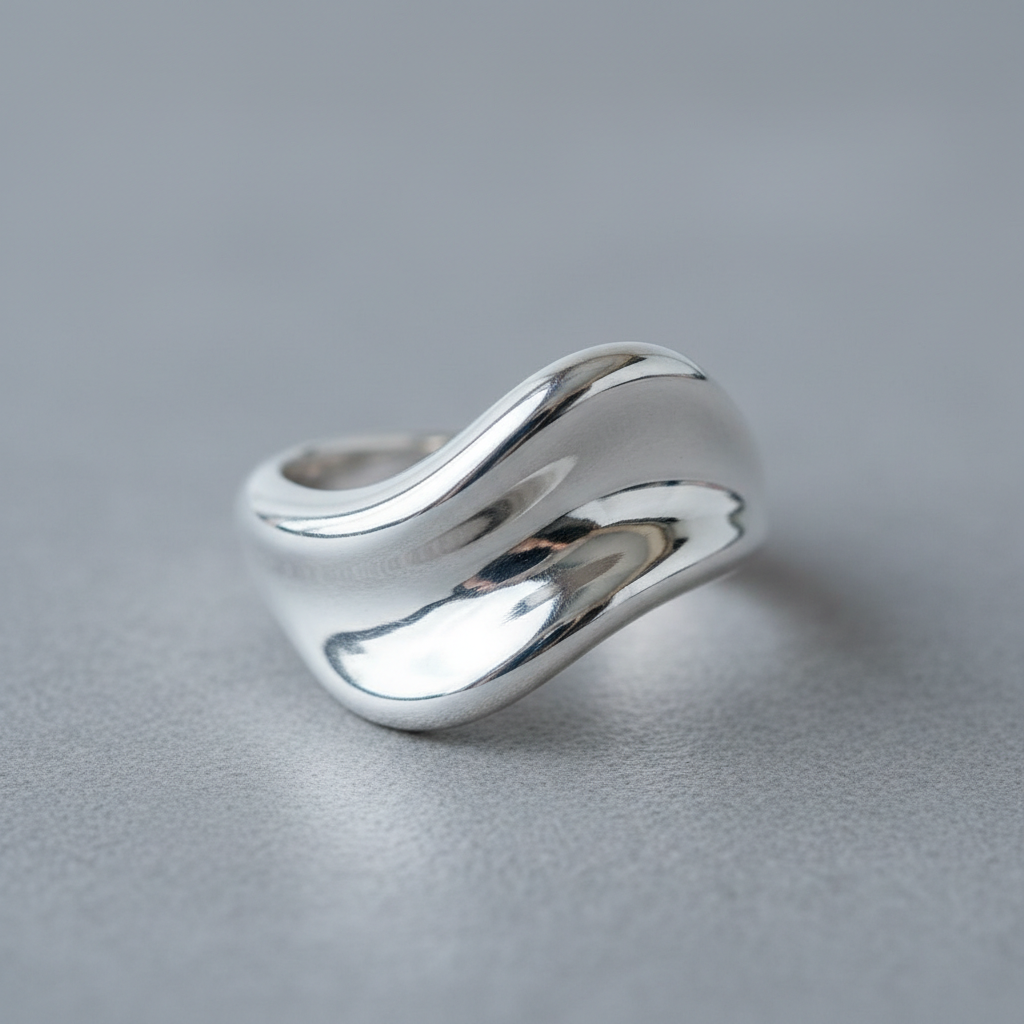 Finished cast sterling silver ring with smooth organic form, polished to a mirror finish